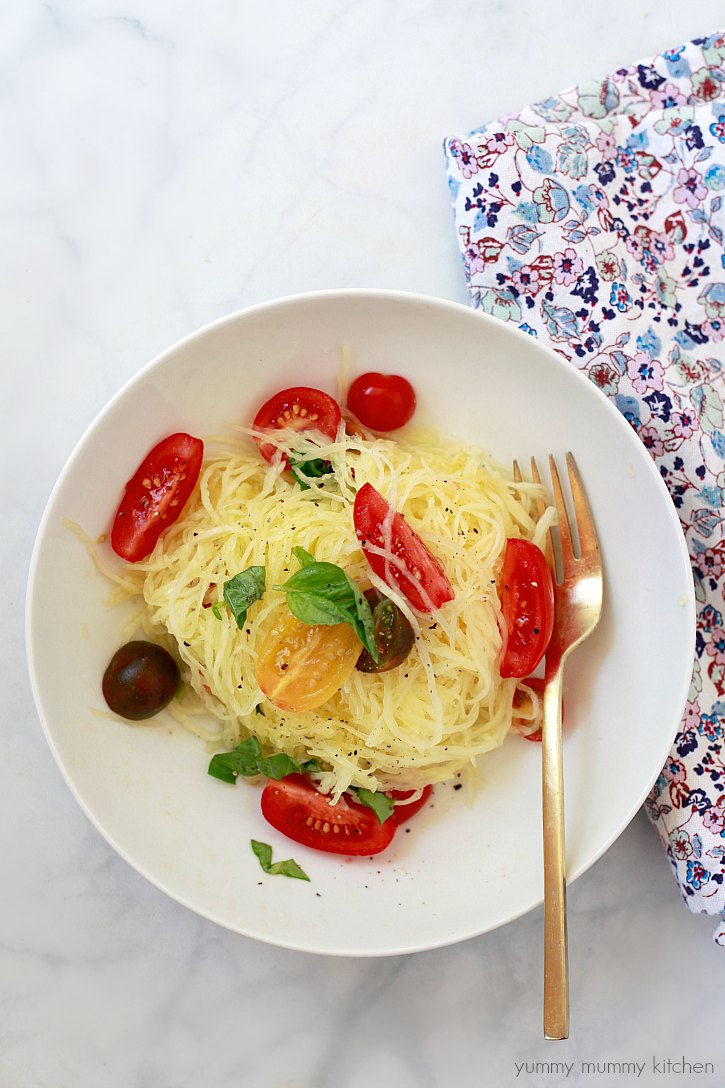 Boiled spaghetti squash noodles with olive oil, fresh tomatoes, and basil. 